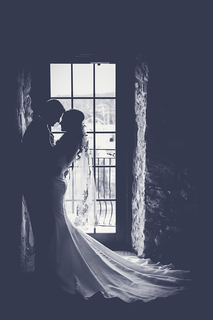 Wedding couple in front of window