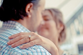 Man dancing with woman wearing diamond engagement ring